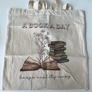 "A Book A Day Keeps Reality Away" Tote Bag